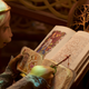 Brea (Anya Taylor-Joy) examines a symbol in her books.